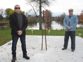 Martintown Cenotaph Project organizing committee members Don Blackadder (left) and Gerry Duguid, on the concrete slab, with two of the white crosses in the background. Photo on Thursday, October 22, 2020, in Martintown, Ont. Todd Hambleton/Cornwall Standard-Freeholder/Postmedia Network