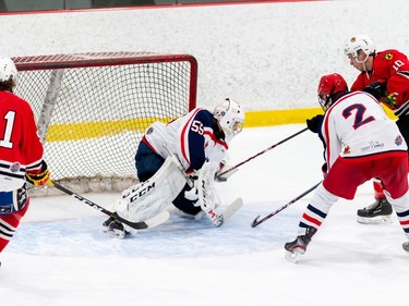 Brockville Braves Colin Stacey, right, pokes at the puck in the glove of the Cornwall Colts goaltender during pre-season play on Sunday October 11, 2020 in Cornwall, Ont. 
Robert Lefebvre/Special to the Cornwall Standard-Freeholder/Postmedia Network