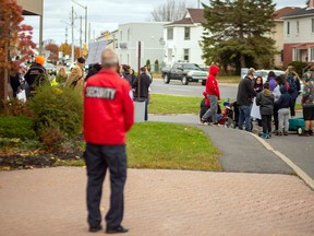 Of the people present at a protest at the Eastern Ontario Health Unit office, the only individuals following any public health protocols were police officers and office security. Photo taken on Saturday October 24, 2020 in Cornwall, Ont. 
John Macgillis/Special to the Cornwall Standard-Freeholder/Postmedia Network