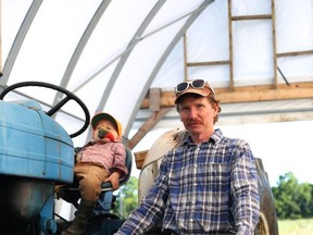 Josh Suppan and his five-year-old son, Lewellyn, at Fat Chance Farmstead on the outskirts of Kingston in South Frontenac on Aug. 30, 2020.