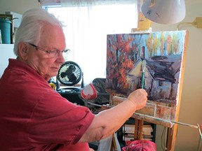 Frank A. Edwards painting in his home studio in Kingston. (Supplied Photo)