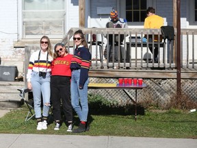 Tina Richardson, Nicole Smith and Sarah Fullerton Meyerhans sported school colours to mark Homecoming weekend on the lawn of their rental house on Johnson Street on Oct. 17, 2020.
