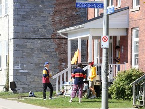 Students sported Queen's University tri-colours and celebrated in small groups on front lawns in the University District to mark Homecoming weekend on Saturday. (Meghan Balogh/The Whig-Standard)