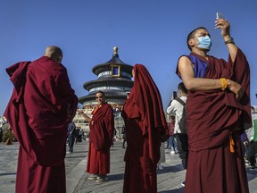 Tibetan Buddhist Monks take photos as they visit the Temple of Heaven on Friday during the national holiday in Beijing, China. China is celebrating its national day marking the 71st anniversary of the People's Republic of China and the Mid-autumn Festival for a week that began on Thursday. (Kevin Frayer/Getty Images)