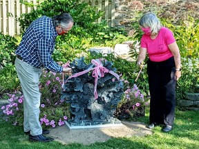 Councillor Dennis OÕConnor and Gananoque Horticultural Society member Joan MacKinnon cut the ribbon on the new statue Ð Heritage: Root Fence Ð which was donated to the GHS Park on Mill Street on September 21.  

Supplied by Gananoque Horticultural Society