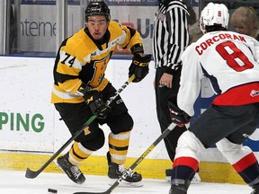 Kingston Frontenacs right-winger Zayde Wisdom tries to get past Windsor Spitfires defenceman Connor Corcoran during Ontario Hockey League action at the Leon's Centre in Kingston in February. (Ian MacAlpine/The Whig-Standard)