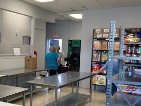 Volunteer Joanne Merkely speaks with Mary Elizabeth McDonald as they help with moving to the new Food Bank location at 497 King Street East.  
Supplied by Shannon Griggs