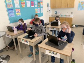 Abpve, students at Precious Blood in Exeter work on their electronic devices. In front from left are Kali Lenssen, Kaelen Horlor and Adrie Bedard, while back from left are Logan Davis and Lucy Drouillard.
