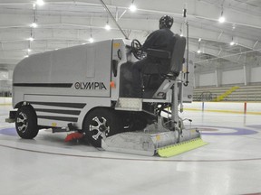 Bob Lauze drove West Perth's new Olympia ice resurfacer, complete with a laser level, last October as final preparations were made for ice installation. ANDY BADER/MITCHELL ADVOCATE