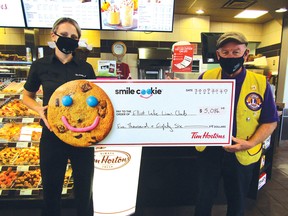 Photo by CINDY WOODS/FOR THE STANDARD
Elliot Lake Tim Hortons store manager Erin Brunelle presents a cheque for $5,086 to Roger Collett, president of the Elliot Lake Lions Club, raised from this year’s Smile Cookie campaign.