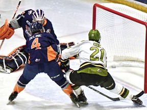 Brandon Coe of the North Bay Battalion scores his second goal of the game against goaltender Anthony Popovich of the Flint Firebirds in Ontario Hockey League action last December at Memorial Gardens. 
File Photo