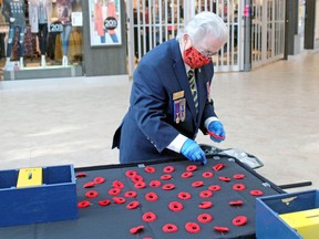 Kathy Whitmore of Royal Canadian Legion Branch 23 sets out poppies on a table at Northgate Shopping Centre, Friday, to launch the 2020 Poppy Campaign.
PJ Wilson/The Nugget