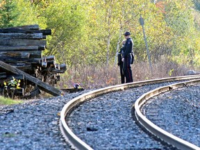 North Bay police investigate the discovery of bones along the Ontario Northland right-of-way near Trout Lake Road, Monday.