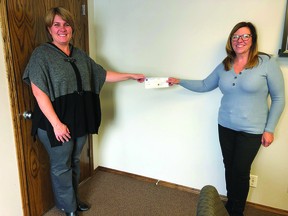 Cathy Couey, right, of the High River District Health Care Foundation presents Nanton's Allison IsBell with her cheque for $5,000 from the Big Screen Harvest Party 50/50 Cash Raffle, which she was the lucky winner of. The draw was a part of the foundation's fundraiser, which included a concert drive-in experience featuring George Canyon and Aaron Pritchett, online auction and raffle. In total, the event raised over $80,000.