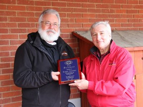 At the Wednesday, Sept. 30 meeting of the Pembroke Kiwanis Club, outgoing club President Roger Steinke, right, handed over leadership of the club to incoming President Robert Lauder. Here, Lauder presents Steinke with a plaque marking the two years he spent as president of the Kiwanis Club of Pembroke. Anthony Dixon