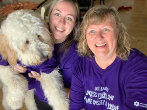 FCS Renfrew County staff Lori Giroux and her daughter Miranda and dog Bentley sport their purple for Dress Purple Day. Submitted photo