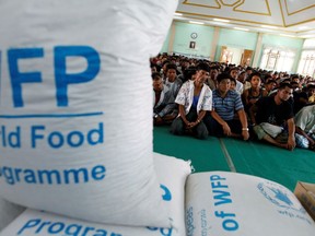 Food rations provided by the World Food Programme (WFP) are pictured in the foreground as Muslims seeking shelter at a monastery listen to a speech by Religious Affairs Minister San Sint. (Soe Zeya Tun/Reuters)