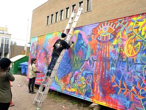 Stratford artists Claire Scott and Amparo Villalobos work on their #LoveWins mural at Revival House in October. Galen Simmons/The Beacon Herald/Postmedia Network