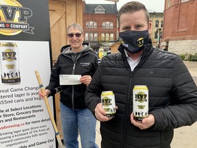 Tyler MacIntosh, co-owner of MVP Brewing, donated a cheque for $200 to Jane Larkworthy of the local Special Olympics chapter. The local brewery is donating five per cent of its sales to sports organizations. (Cory Smith/The Beacon Herald)
