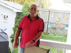 Hugh Kerr stands on the deck outside his Green Haven Estates home in Sarnia. The Valley Axe outdoor stage is about 130 metres behind his fence. (Tyler Kula/The Observer)