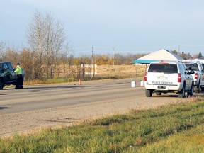 Peace officers and RCMP attend to the scene of a road accident where a fatality was reported Wednesday at the section of Highway 16A between Jennifer Heil Way in Spruce Grove and Veterans Boulevard in Stony Plain.