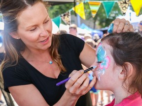 Misty Muyres of Bee's Knees Face Painting puts the final touches on Olivia Steven's face during an earlier Spruce Grove Public Market hosted by the Spruce Grove City Centre Business Association.