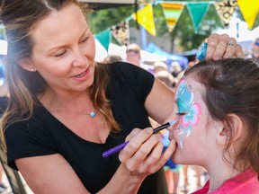 Misty Muyres of Bee's Knees Face Painting puts the final touches on Olivia Steven's face during a previous Public Market hosted by the Spruce Grove City Centre Business Association (CCBA). Photo by Josh Aldrich/Postmedia.