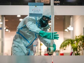 Members of Spains Military Emergencies Unit (UME) carry out disinfection procedures at a temporary coronavirus disease COVID-19 testing site in a municipal pavilion in the Puente de Vallecas district in Madrid, Spain, on Thursday, Oct. 1, 2020.