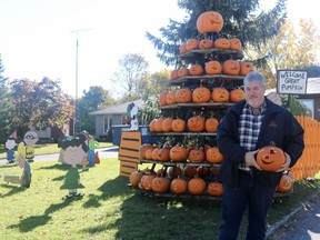 Matt Suckel, co-chair of the Waterford Pumpkinfest, stands near one of the two pumpkin pyramids prepared for this year's event. A smaller festival will be taking place this year on Oct. 16, 17, and 18. (ASHLEY TAYLOR)
