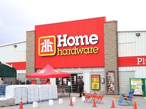 Customers wait for their orders outside the Home Hardware in Lively, Ont. on Thursday, May 7, 2020.