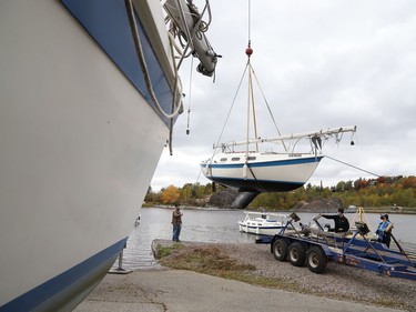 A crane was used to lift a sailboat out of Ramsey Lake at the Sudbury Yacht Club in Sudbury, Ont. on Friday October 2, 2020. The crane was used to remove all the boats from the water to wrap-up the sailing season. John Lappa/Sudbury Star/Postmedia Network