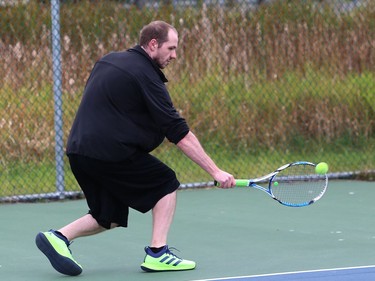 Mark Rzezniczak returns a ball during a friendly game of tennis at James Jerome Sports Complex on Tuesday.
