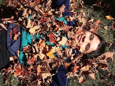 Riwaj Sigdel, 9, is covered in leaves after rolling around his yard in Sudbury, Ont. on Thursday October 8, 2020. John Lappa/Sudbury Star/Postmedia Network