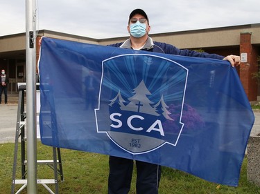 Michael Riutta prepares to raise the school flag at the official opening of Sudbury Christian Academy on Dublin Street in Sudbury, Ont. on Friday October 9, 2020. The private school is located at the former location of St. Raphael Catholic Elementary School. John Lappa/Sudbury Star/Postmedia Network