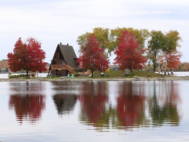 Radiant red foliage at the Sudbury Yacht Club reflects off the surface of Ramsey Lake on Friday. John Lappa/Sudbury Star