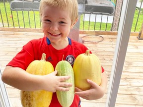 Corbin MacLean, 6, hugs his garden produce. The Home Garden project was a big success, with more than 300 gardens planted throughout Greater Sudbury.
