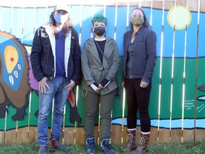 Artists Wallace Gillard, left, Raven Debassige and Adrienne Assinewai pose for a photo during a ceremony to unveil their mural, Mino-bimaadiziwin – The Good Life, at Better Beginnings, Better Futures' main site, 450 Morin Ave., on Tuesday, October 13, 2020. Inspired by traditional Woodland art, the mural depicts seven animals representing the Seven Grandfather Teachings, while other elements symbolize Better Beginnings programming and connections within the community. Ben Leeson/The Sudbury Star/Postmedia Network