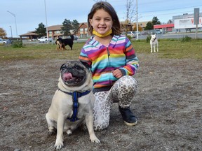 Jerrica Wilks poses with Thugg the pug at the Minnow Lake Dog Park. Jim Moodie/Sudbury Star