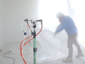 Adam Barton, of AeroBarrier Canada, checks over equipment during a demonstration at a home in Hanmer, Ont. on Thursday October 22, 2020. The envelope sealing technology is designed to seal the building for residential, multi-family, and commercial buildings. According to a press release issued for the company, the product provides energy efficiency by suppressing air leakage in a home or building. The AeroBarrier launch in Northern Ontario was held in conjunction with SLV Homes and the event was sponsored by Enbridge.