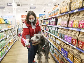 Allyson O'Sullivan and seven-month-old Rue search for doggie snacks at the opening of Ren's Pets, a Canadian specialty retailer of pet supplies, located at the RioCan Centre in Sudbury, Ont. on Friday October 23, 2020. The Sudbury store features more than 7,000 products with aisles of dog and cat food, freezers for raw and frozen pet food, displays of treats and toys, plus a special grooming section. It will also house Ren's second Paw Spa Dog Wash for the chain.