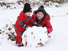 Kamma Montague and her son, Kaynnan, 2, make a snowman at Fielding Memorial Park in Greater Sudbury, Ont. on Monday October 26, 2020.