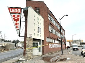 A triangular hotel on an urban city corner, sits derelict and empty.