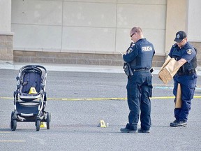 Greater Sudbury Police officers collect evidence at the site of a stabbing incident outside the Michaels store on Marcus Drive in June of last year. Alex Stavropolous, 26, was found guilty in the attack, which injured a woman and her child.