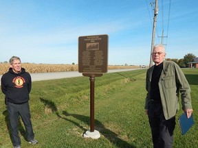 Plympton-Wyoming Historical Society members Bill Munro (left) and Gord MacKenzie stand beside the new commemorative marker recognizing the 1902 Wanstead Train Disaster, which killed 29 people and injured 31. Carl Hnatyshyn/Sarnia This Week