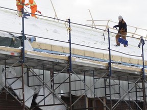 Contractors working on the roof of the Archie Dillon Sportsplex were out with their shovels on Tuesday, having to clear off some snow before continuing with the task at hand.

RICHA BHOSALE/The Daily Press