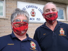 Dianne Hodges, left, president of the Royal Canadian Legion Branch 153 in Tillsonburg, and Don Burton, local poppy campaign chair, model the Legion fask masks, which are being sold as a fundraiser to support the local Legion. (Chris Abbott/Norfolk and Tillsonburg News)