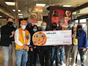 The Cochrane Tim Horton franchise have added up the numbers of the smile cookies and presented the Lions Club with a hefty cheque.