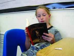 Hannah Miller, a grade 5 student at Vulcan Prairieview Elementary (VPE) School, reads The Lion King, which had been donated by the Rainbow Literacy and Learning Society. The society created a bag of engaging titles for each student to take home and enjoy. On its Facebook page, VPE thanked Rainbow Literacy and Learning Society for the “amazing donation of books.”