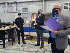 Ben Nicholls, left, a machinist apprentice at AarKel Tool and Die, accepts his Canadian Tooling and Machining Association Apprentice Award from Chris Harcott, CTMA president, and Robert Cattle,right, CTMA executive director on Oct. 6 at the Wallaceburg facility. Submitted