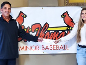 Chris Wilkins, left, presents Erin Briggs her St. Thomas Minor Baseball Association scholarship. (Contributed photo)